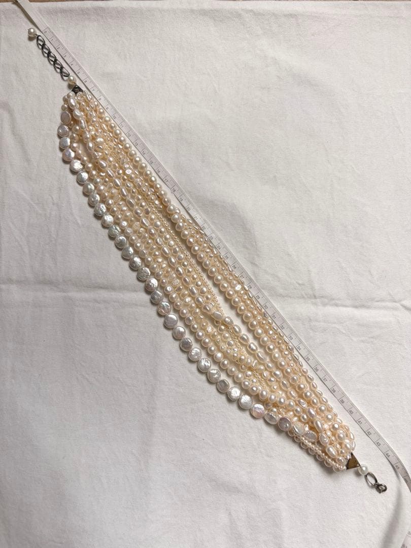 Kuro Multiple Freshwater Pearl Necklace with white freshwater pearls of different sizes on display