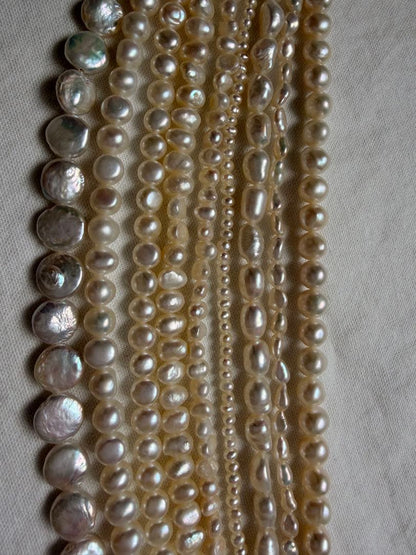 Kuro Multiple Freshwater Pearl Necklace with white freshwater pearls of different sizes on display