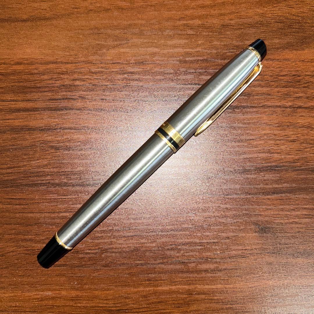Vintage Waterman fountain pen with case showing minor scratches and dirt on the pen body