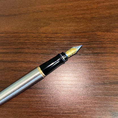 Vintage Waterman fountain pen with case showing minor scratches and dirt on the pen body