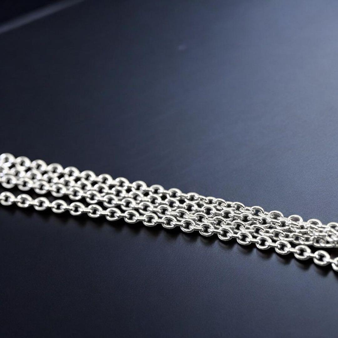 Tasaki Akoya pearl necklace pendant with round genuine pearls and silver clasp on a white background