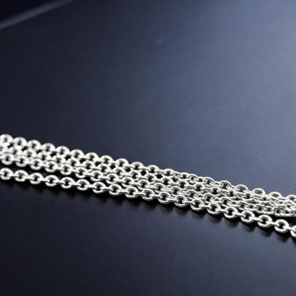 Tasaki Akoya pearl necklace pendant with round genuine pearls and silver clasp on a white background