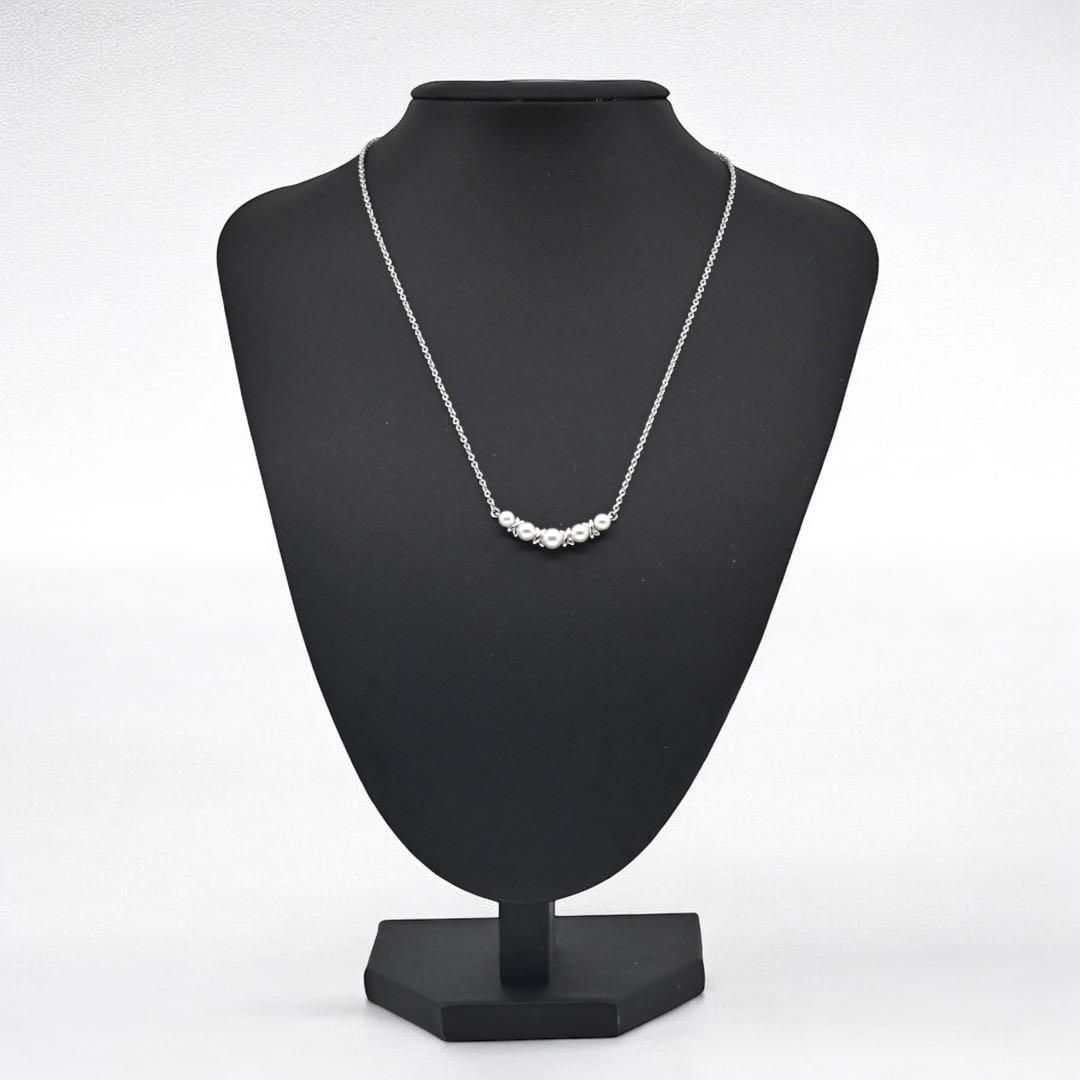 Tasaki Akoya pearl necklace pendant with round genuine pearls and silver clasp on a white background