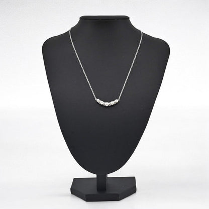 Tasaki Akoya pearl necklace pendant with round genuine pearls and silver clasp on a white background
