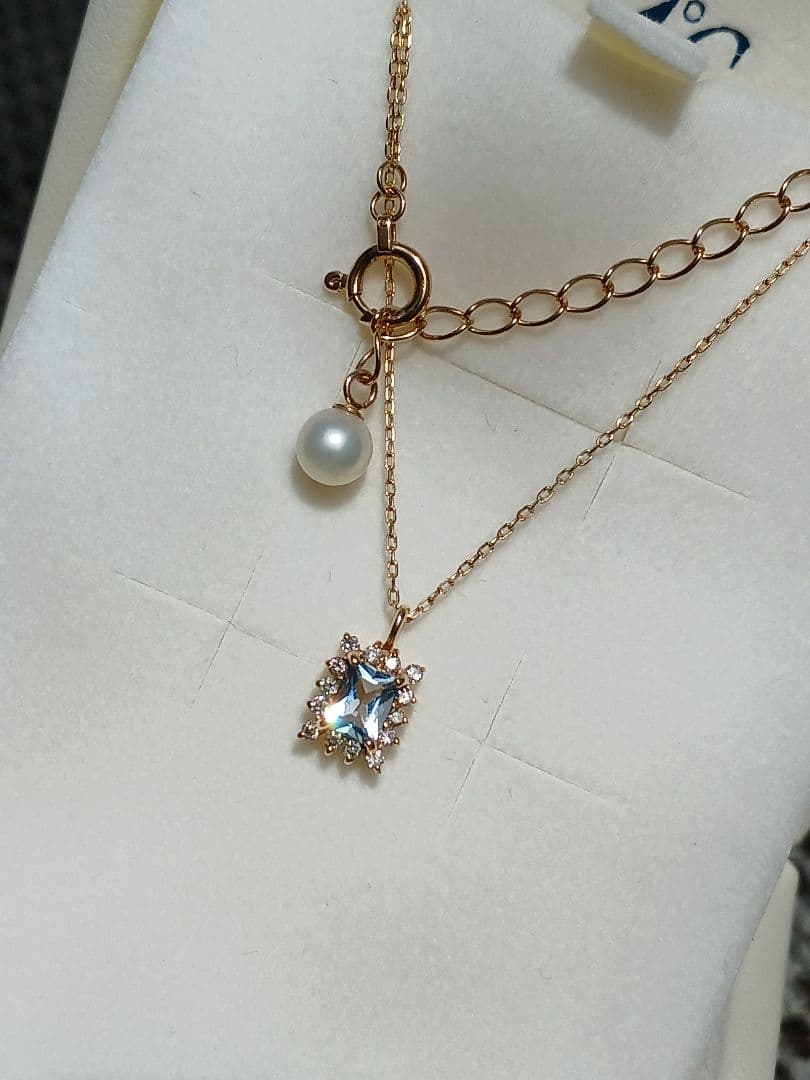 Moon Label necklace in 10K yellow gold featuring aquamarine, 0.07ct diamond, and 4mm Akoya pearl on a 43cm chain
