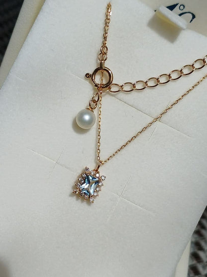 Moon Label necklace in 10K yellow gold featuring aquamarine, 0.07ct diamond, and 4mm Akoya pearl on a 43cm chain