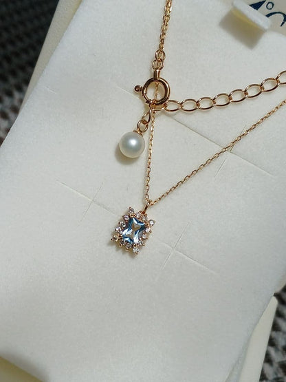 Moon Label necklace in 10K yellow gold featuring aquamarine, 0.07ct diamond, and 4mm Akoya pearl on a 43cm chain