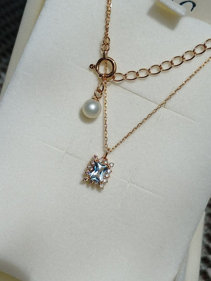 Moon Label necklace in 10K yellow gold featuring aquamarine, 0.07ct diamond, and 4mm Akoya pearl on a 43cm chain