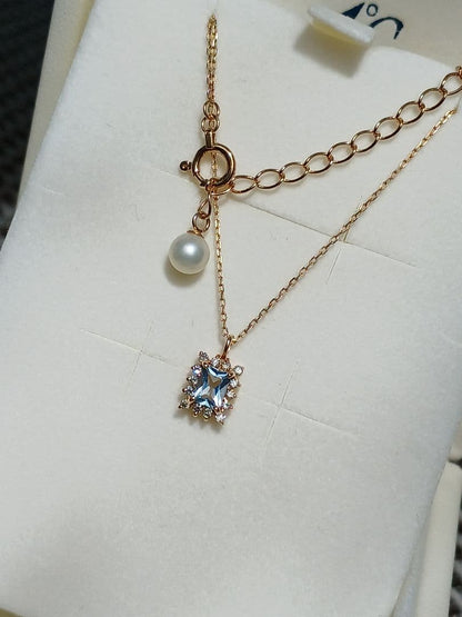 Moon Label necklace in 10K yellow gold featuring aquamarine, 0.07ct diamond, and 4mm Akoya pearl on a 43cm chain