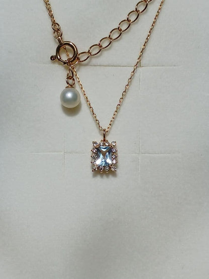 Moon Label necklace in 10K yellow gold featuring aquamarine, 0.07ct diamond, and 4mm Akoya pearl on a 43cm chain