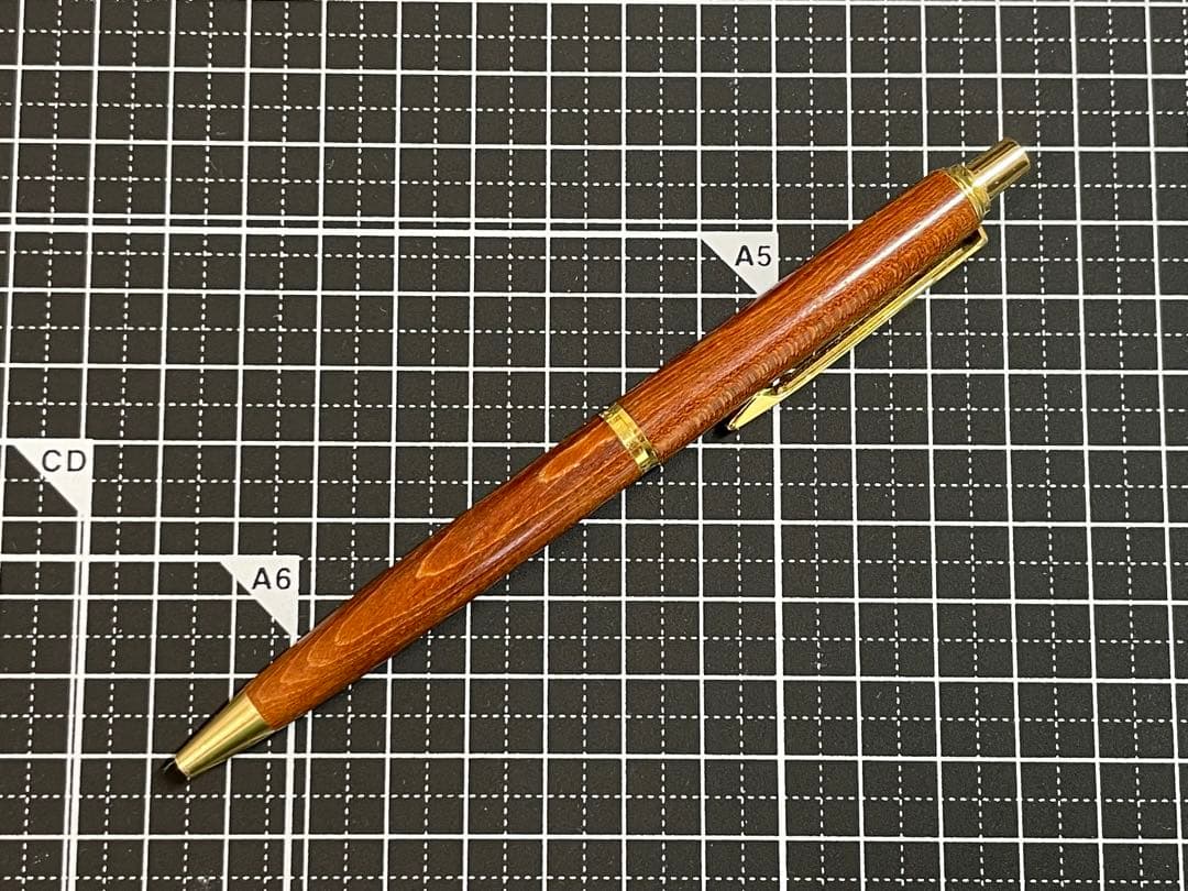 Pilot Grandee ballpoint pen with brown wooden body and gold metal accents