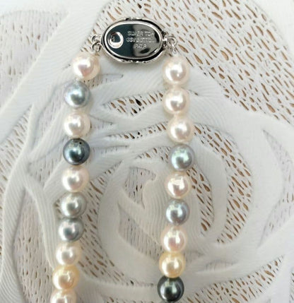 Akoya pearl necklace with 6mm round white, gold, green, and light gray pearls on a 42.5cm strand with silver push clasp
