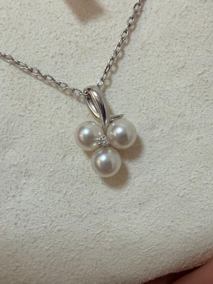 Mikimoto Akoya pearl and diamond necklace with three-strand design and floral motif on silver-colored metal chain