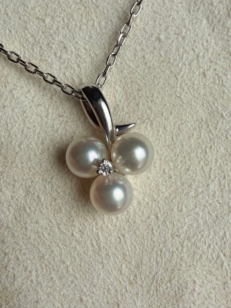 Mikimoto Akoya pearl and diamond necklace with three-strand design and floral motif on silver-colored metal chain