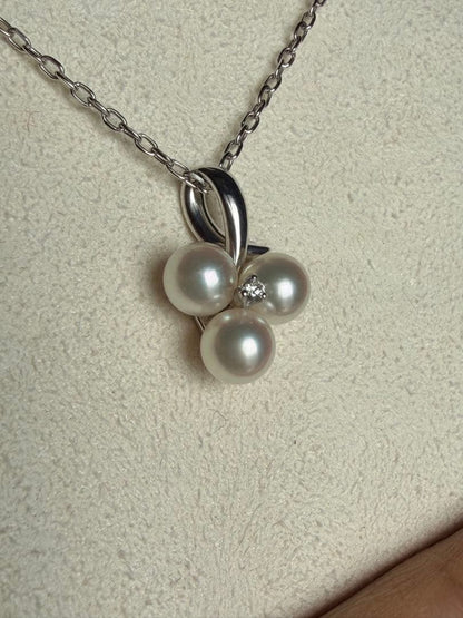 Mikimoto Akoya pearl and diamond necklace with three-strand design and floral motif on silver-colored metal chain