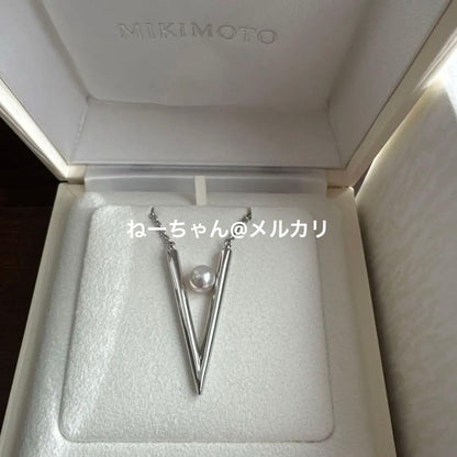 MIKIMOTO V Code silver pendant displayed with box, ribbon, and shop card