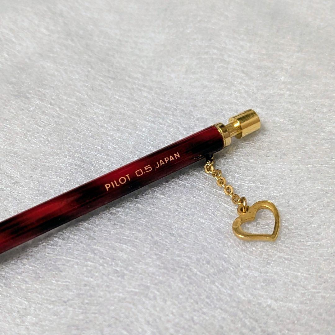 PILOT Mechanical Pencil in red tortoise marble pattern with gold accents and heart charm, displayed with velvet pen case and cloth box