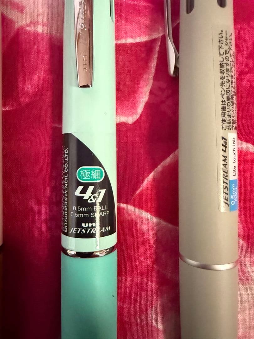 Set of four multi-color ballpoint pens, some featuring mechanical pencil function