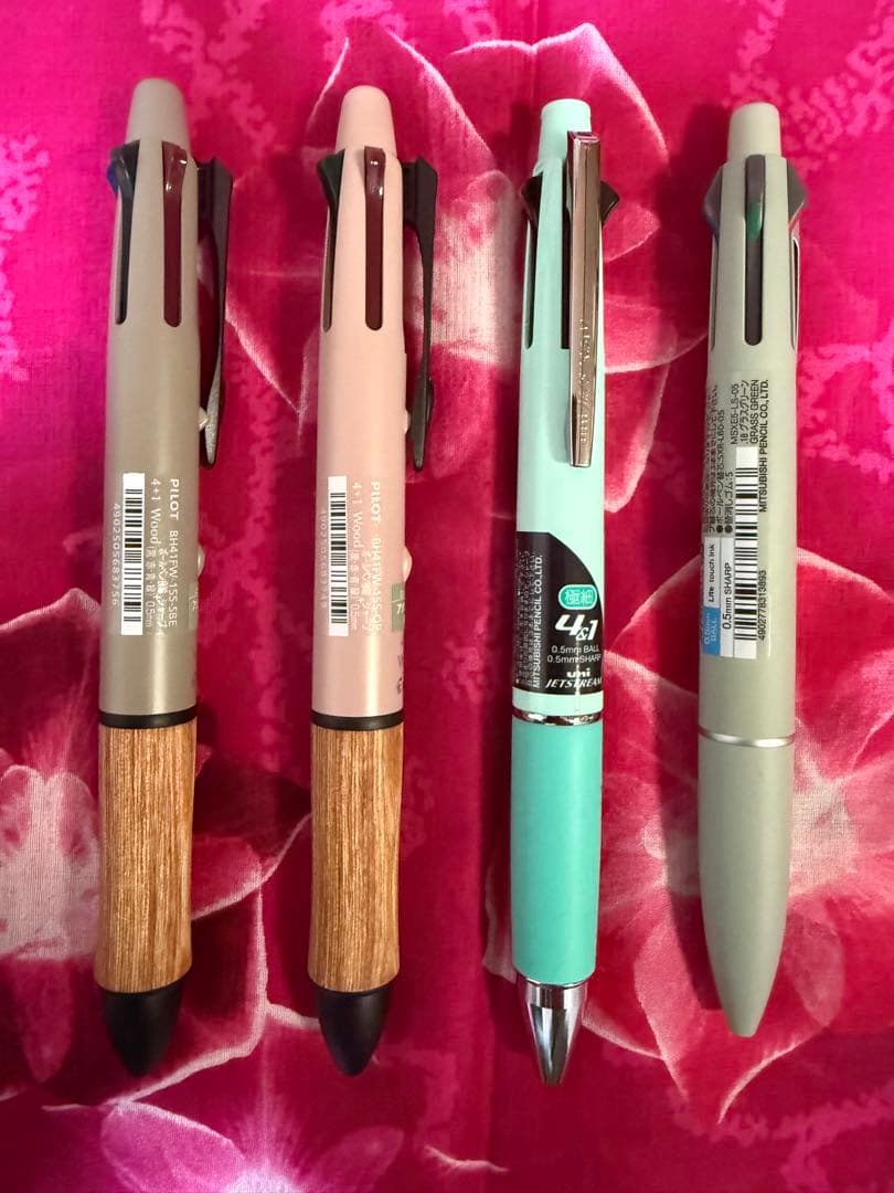 Set of four multi-color ballpoint pens, some featuring mechanical pencil function