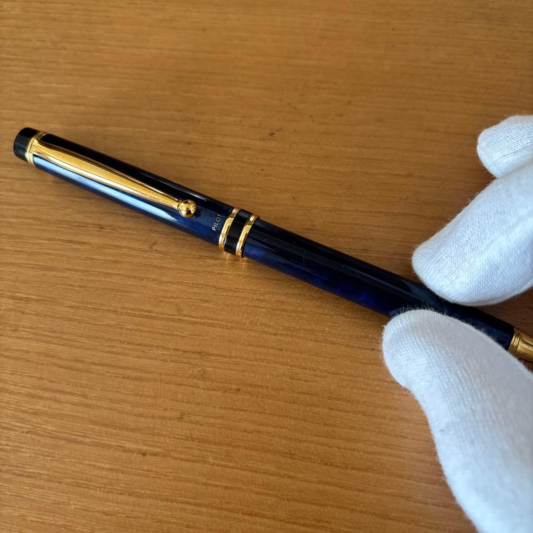 Pilot ballpoint pen with blue body, gold decorative accents, two-tone design, and rotating mechanism