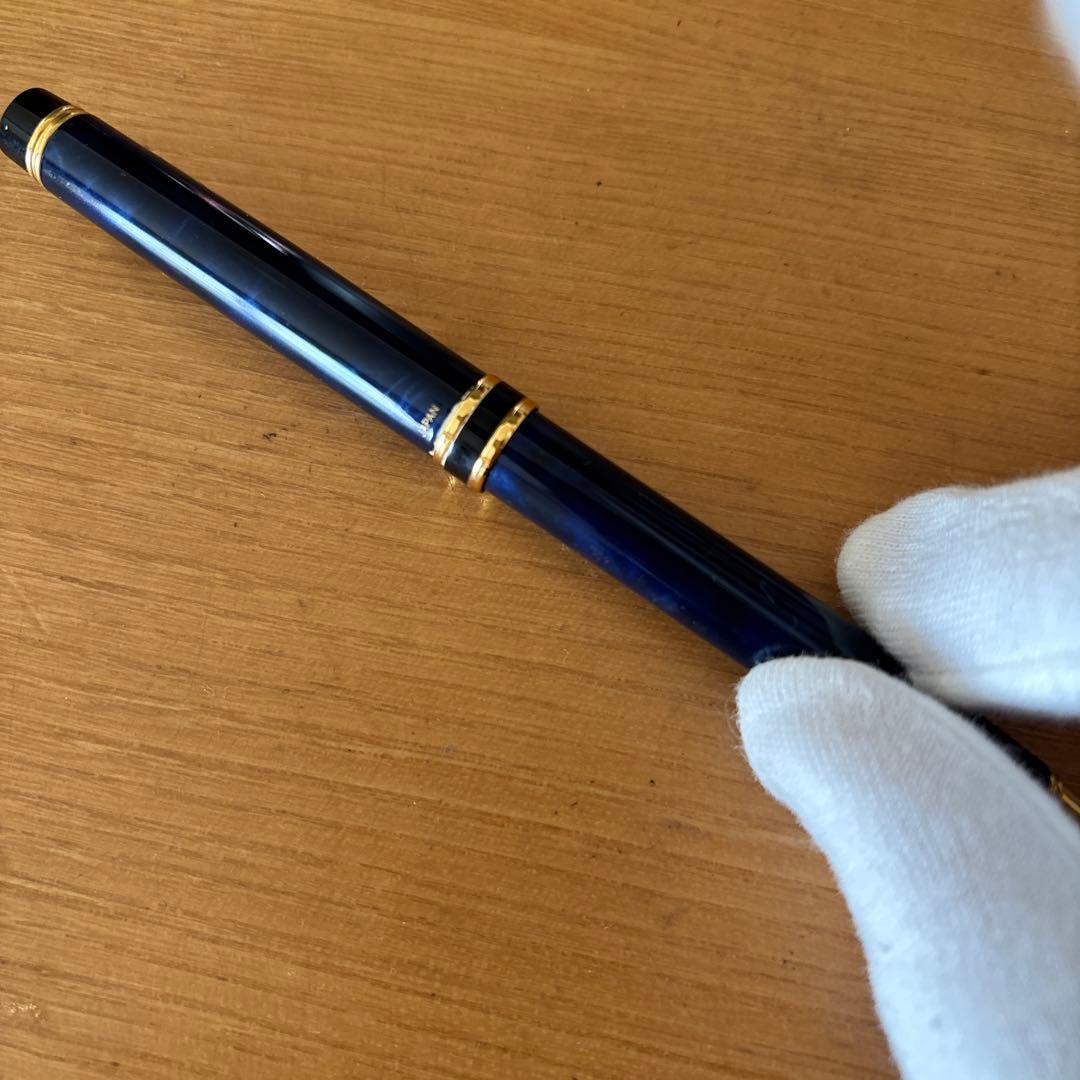 Pilot ballpoint pen with blue body, gold decorative accents, two-tone design, and rotating mechanism