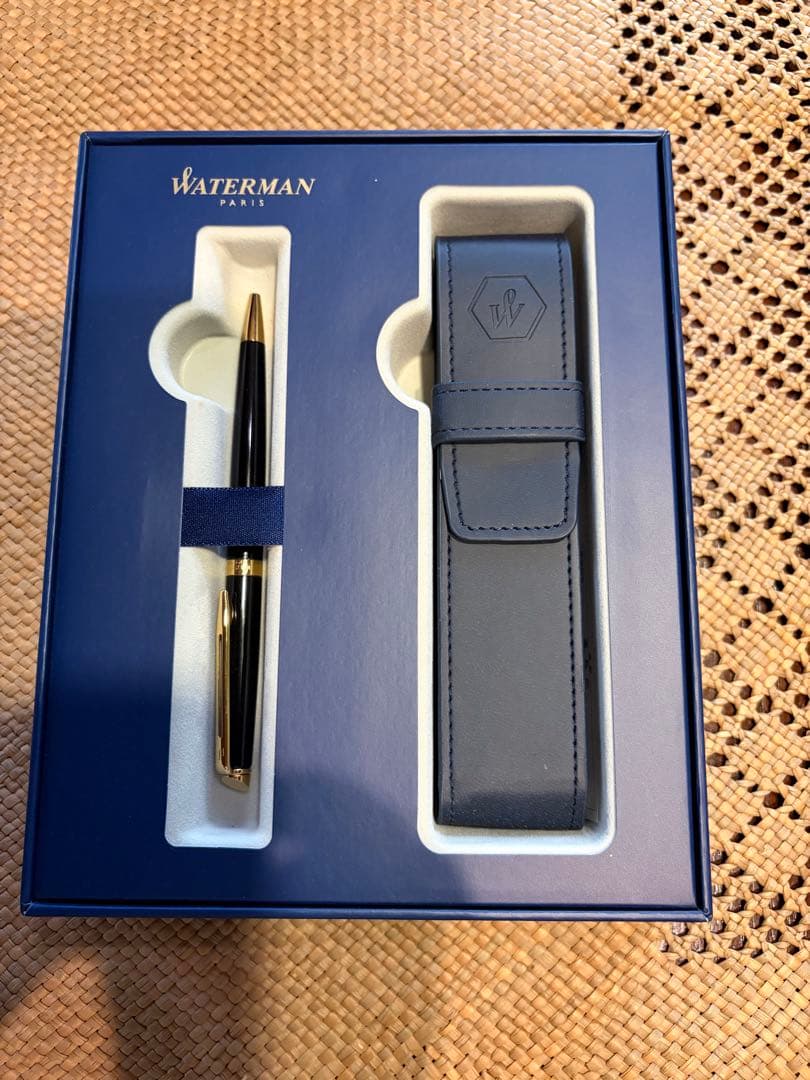 Waterman ballpoint pen in black and gold with matching pen case set on white background
