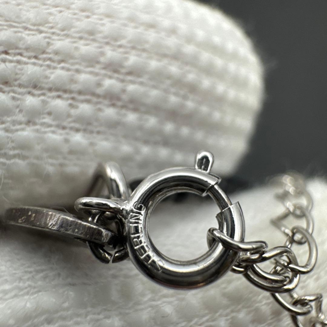 Mikimoto M Mark genuine pearl pendant with thin black coral silver bead necklace on white background