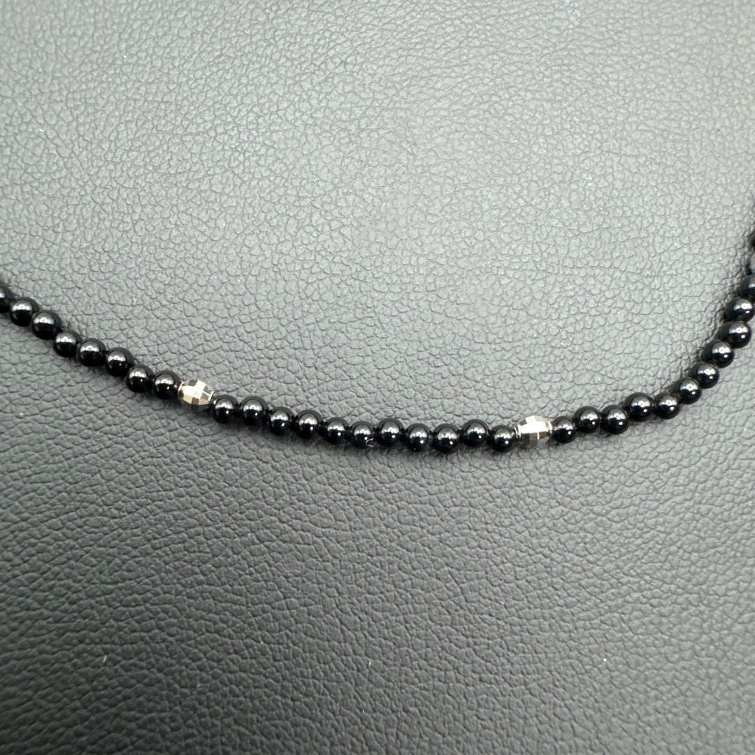 Mikimoto M Mark genuine pearl pendant with thin black coral silver bead necklace on white background
