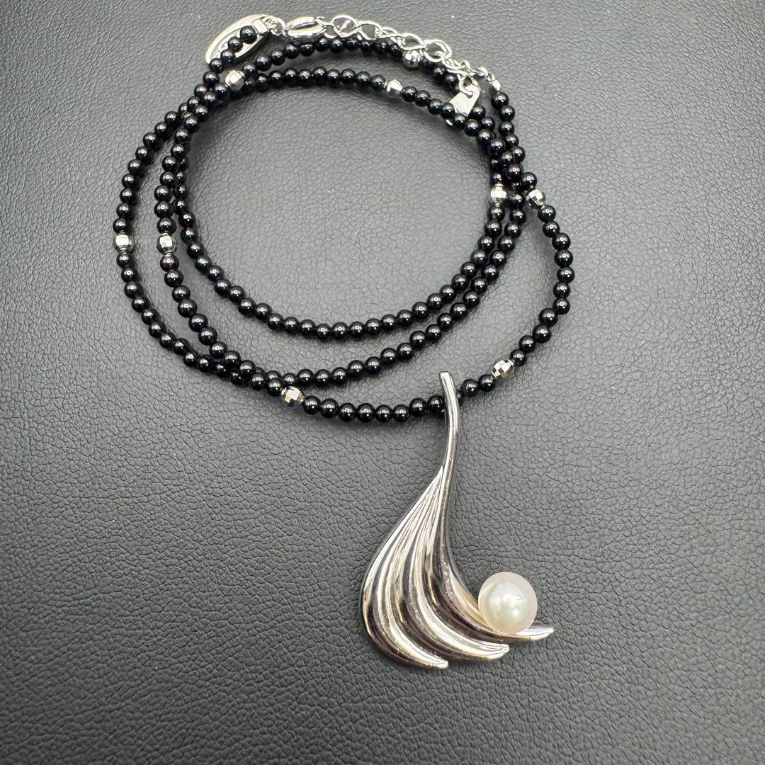 Mikimoto M Mark genuine pearl pendant with thin black coral silver bead necklace on white background