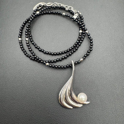 Mikimoto M Mark genuine pearl pendant with thin black coral silver bead necklace on white background