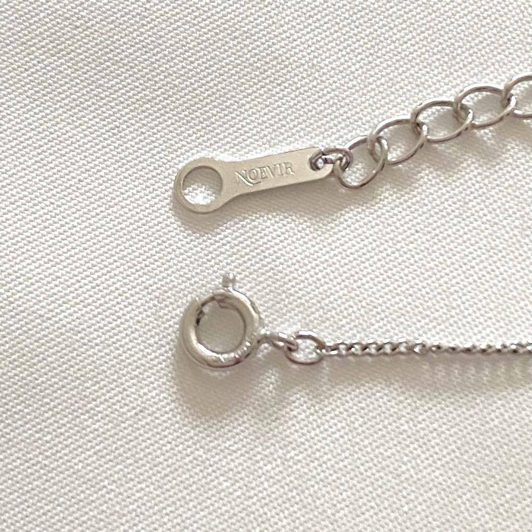 Silver Tasaki x Noevnir single pearl necklace with simple design on a white background