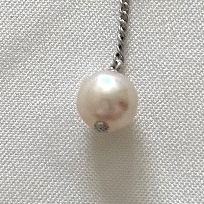 Silver Tasaki x Noevnir single pearl necklace with simple design on a white background
