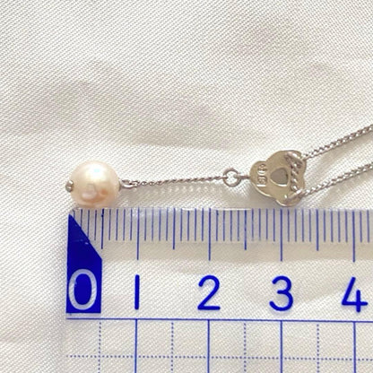 Silver Tasaki x Noevnir single pearl necklace with simple design on a white background