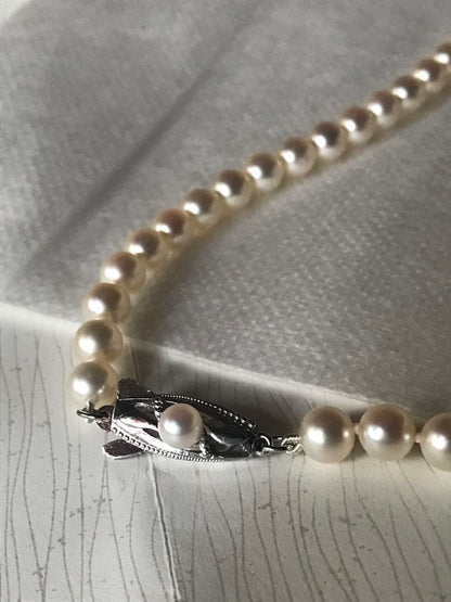 Mikimoto pearl necklace with M charm in white gold featuring 5.5-5.9mm pearls and pouch