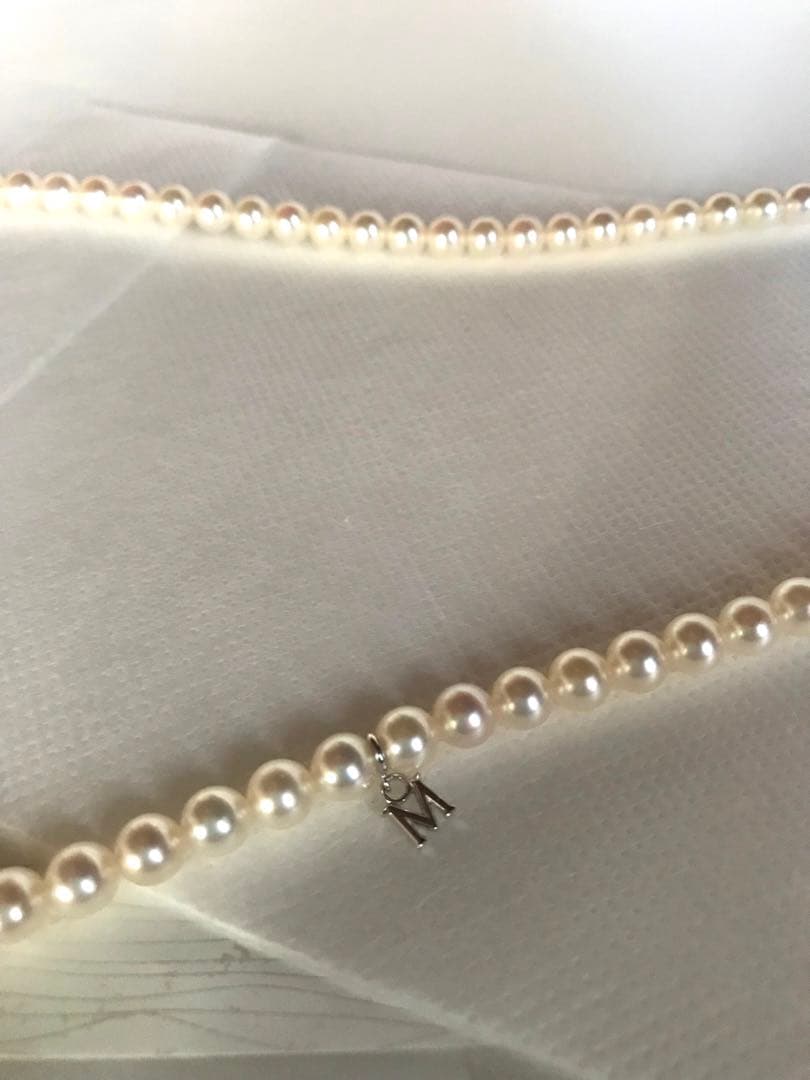 Mikimoto pearl necklace with M charm in white gold featuring 5.5-5.9mm pearls and pouch