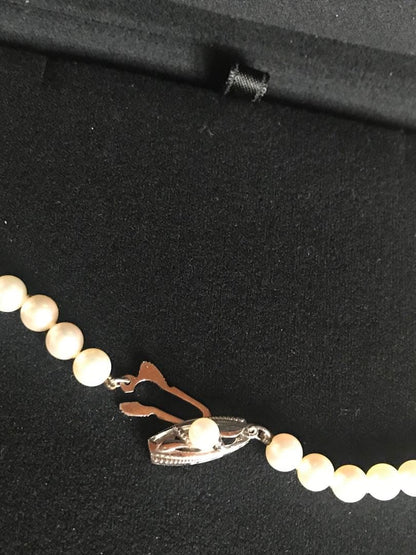 Mikimoto pearl necklace with M charm in white gold featuring 5.5-5.9mm pearls and pouch