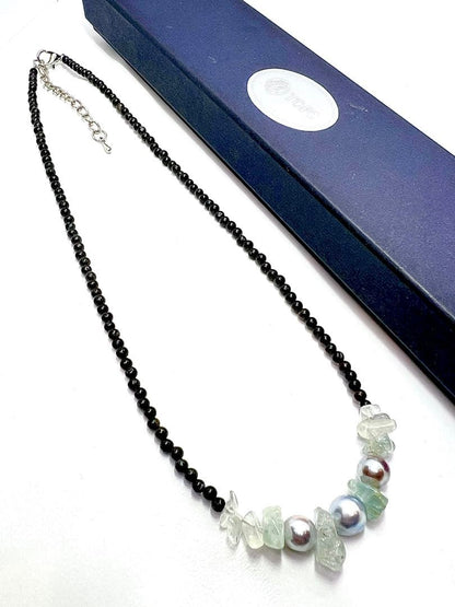 Akoya pearl necklace with natural blue pearls, aquamarine stones, and black tourmaline on a 42 to 47 cm chain