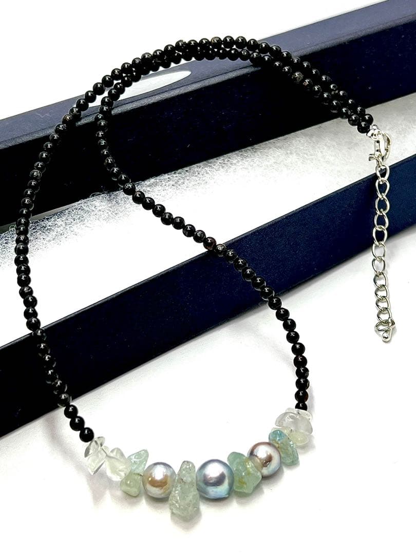 Akoya pearl necklace with natural blue pearls, aquamarine stones, and black tourmaline on a 42 to 47 cm chain