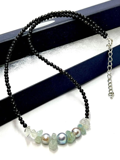 Akoya pearl necklace with natural blue pearls, aquamarine stones, and black tourmaline on a 42 to 47 cm chain