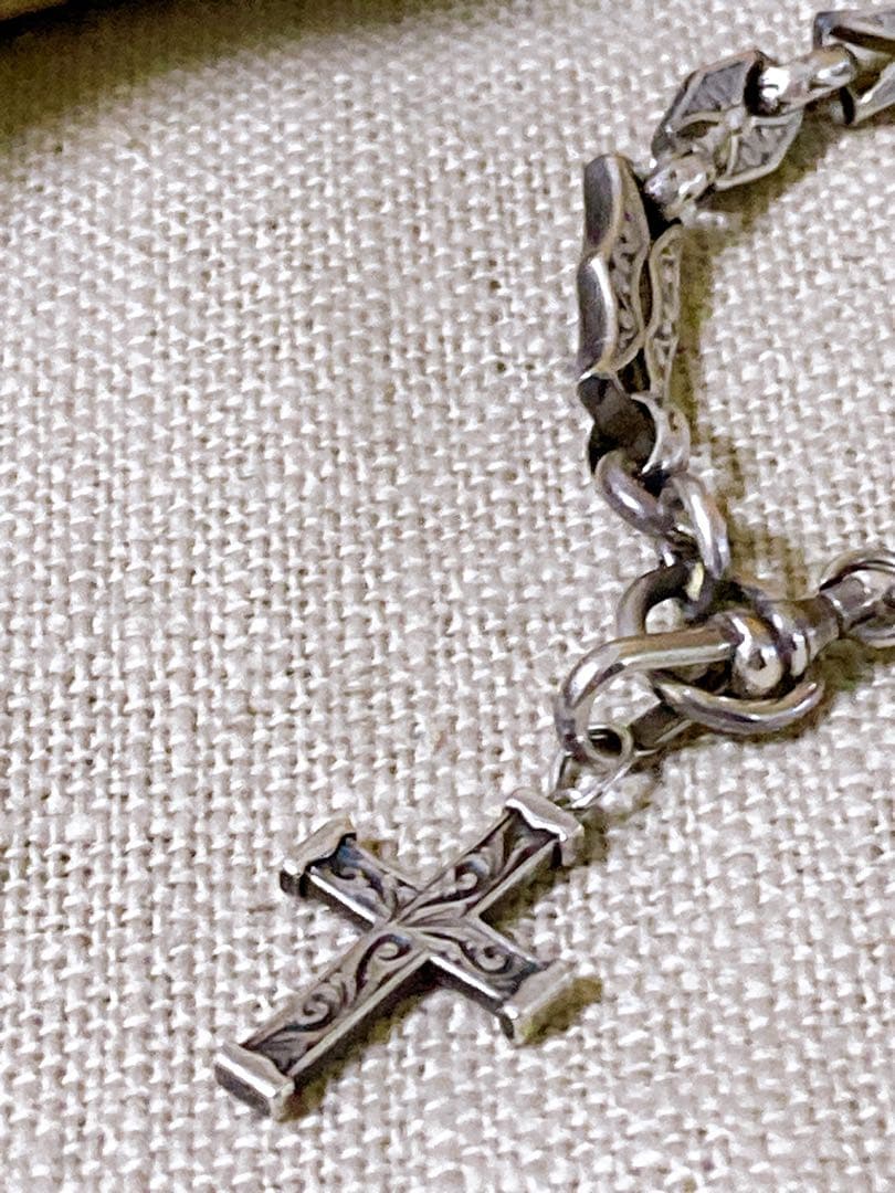Agete Silver 925 bracelet featuring a cross motif and a pendant top on a white background