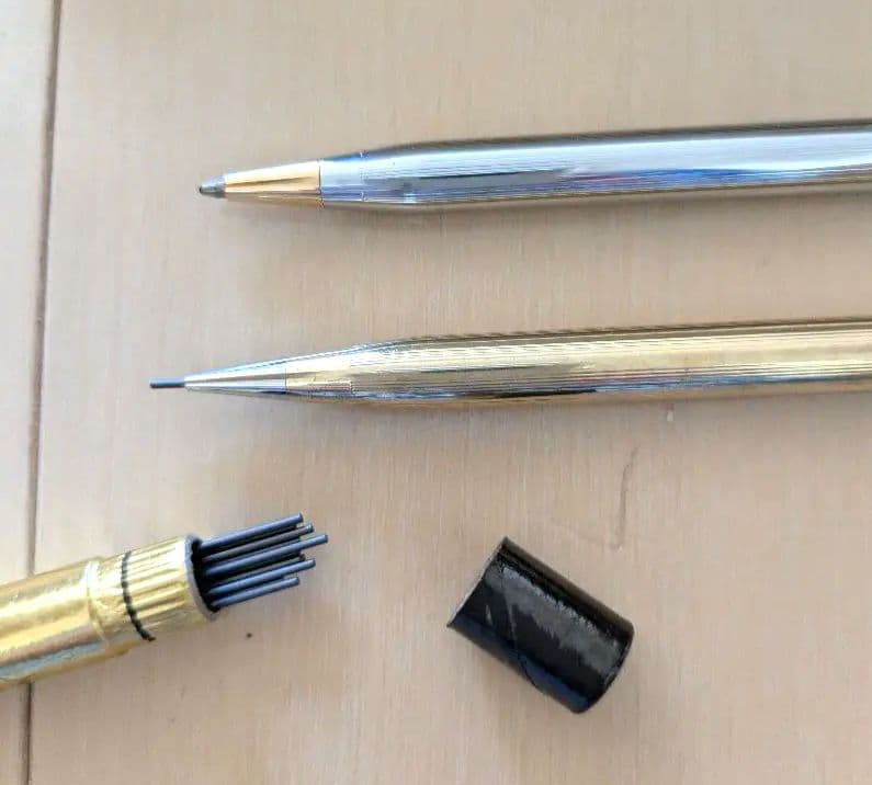 CROSS set of gold mechanical pencil and silver ballpoint pen displayed with black case and instruction manual