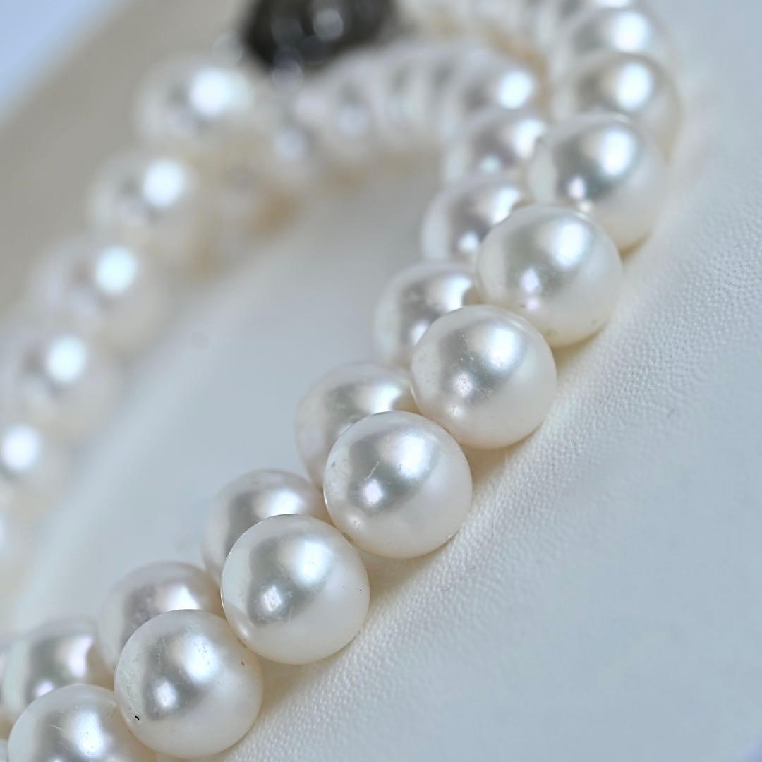 Hanadama Akoya pearl necklace with round 8-8.5mm pearls and silver fastener on a white background