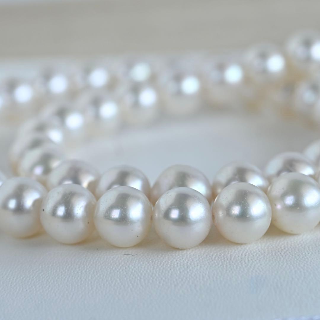 Hanadama Akoya pearl necklace with round 8-8.5mm pearls and silver fastener on a white background