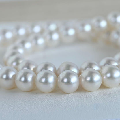 Hanadama Akoya pearl necklace with round 8-8.5mm pearls and silver fastener on a white background