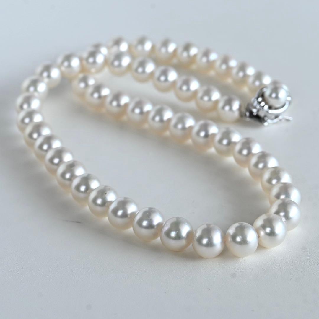 Hanadama Akoya pearl necklace with round 8-8.5mm pearls and silver fastener on a white background