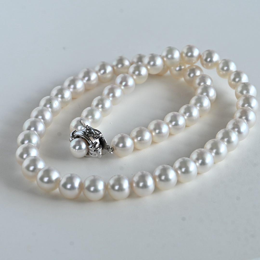 Hanadama Akoya pearl necklace with round 8-8.5mm pearls and silver fastener on a white background