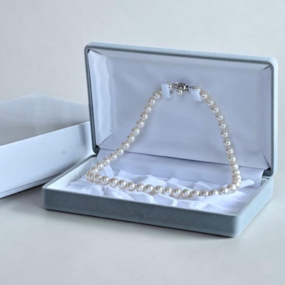 Hanadama Akoya pearl necklace with round 8-8.5mm pearls and silver fastener on a white background