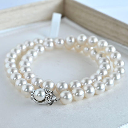 Hanadama Akoya pearl necklace with round 8-8.5mm pearls and silver fastener on a white background