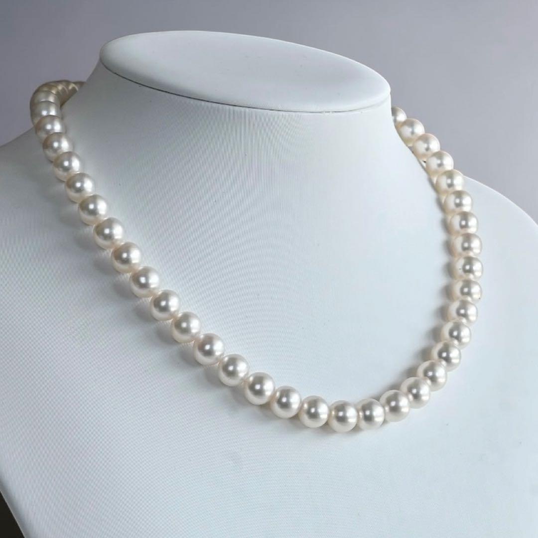 Hanadama Akoya pearl necklace with round 8-8.5mm pearls and silver fastener on a white background