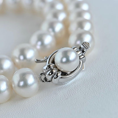 Hanadama Akoya pearl necklace with round 8-8.5mm pearls and silver fastener on a white background